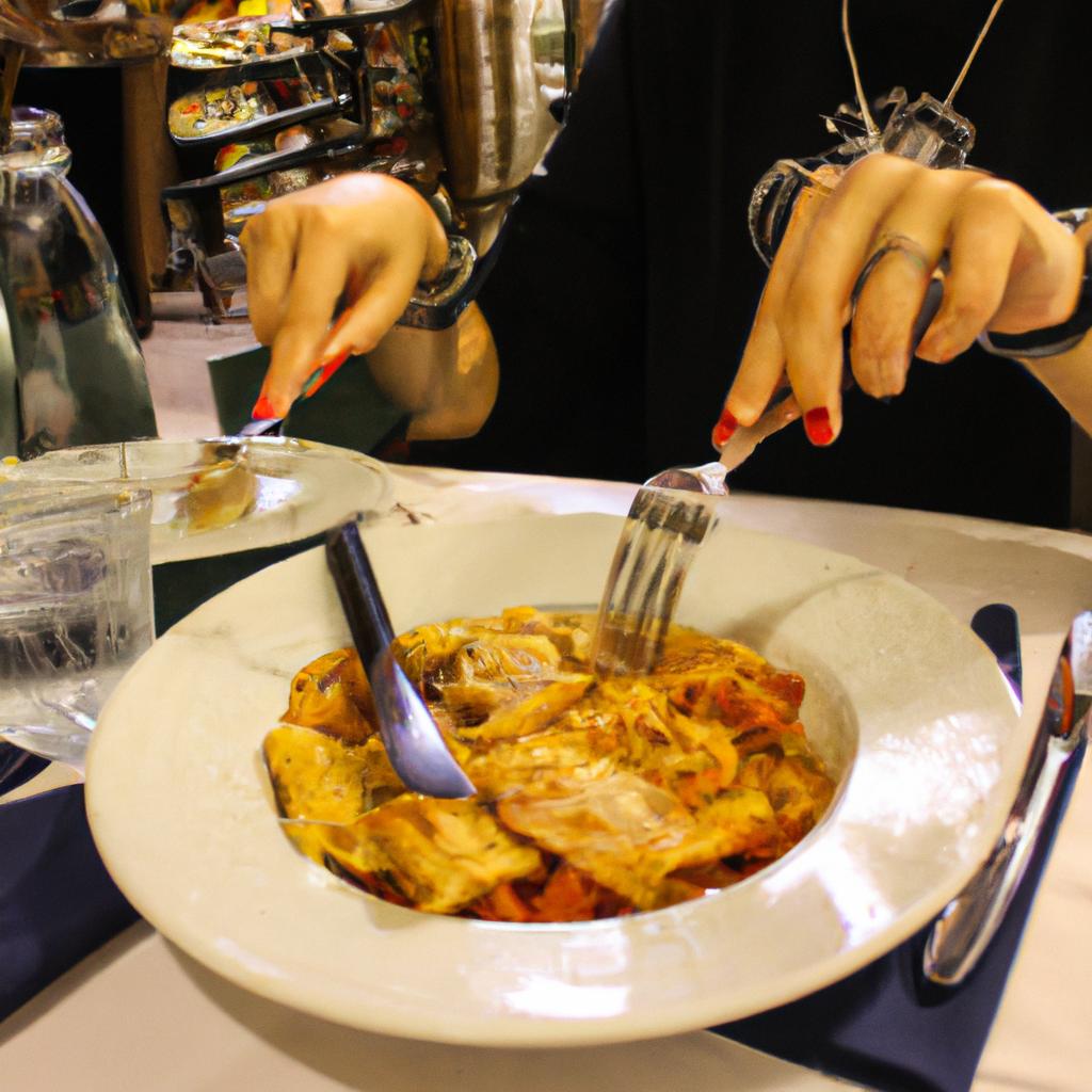 Person eating Italian food at restaurant